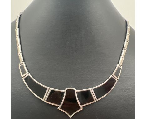 A silver and black onyx Art Deco style fixed pendant flat link necklace, with clip clasp. Approx. 16 inches long, silver mark