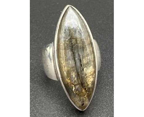 A large silver modern design dress ring set with a marquise cut piece of Labradorite. Silver mark inside of band. Size N. 