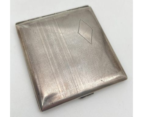 A vintage silver cigarette case of Art Deco design, with engine turned decoration front &amp; back. Diamond shaped empty cart