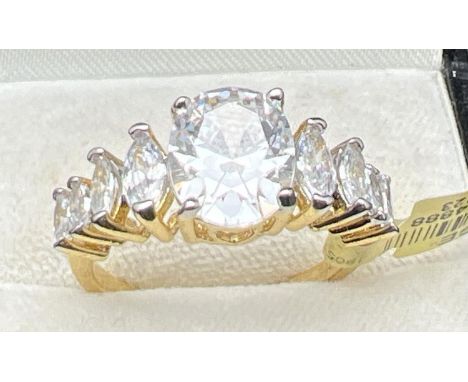 A 14ct gold plated cocktail ring set with clear Swarovski crystals, new with tags. Large central oval cut stone with 4 gradua