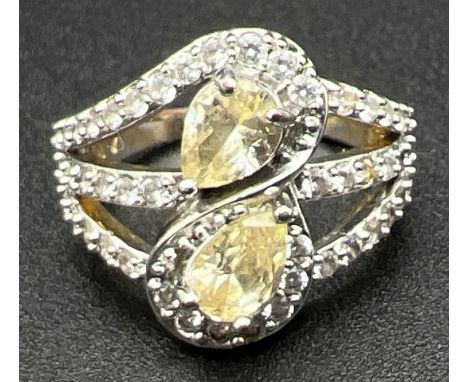 A 14ct gold plated cocktail ring set with Swarovski crystals. 2 teardrop cut pale lemon crystals set in an 'S' design setting