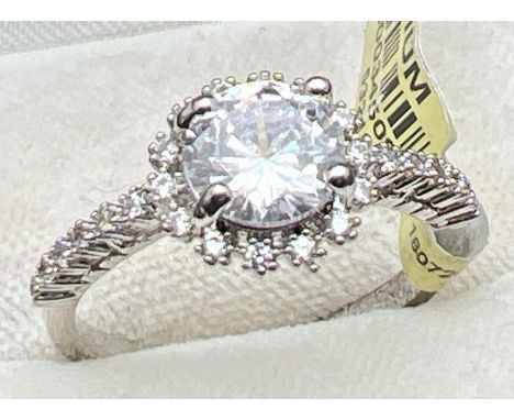 A rhodium plated cocktail ring set with Swarovski crystals (new with tags). Central round stone surrounded by smaller round c