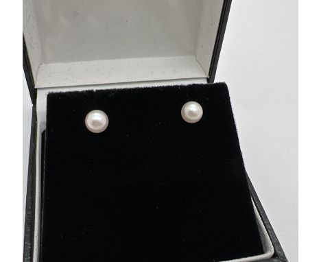 A pair of 9ct gold pearl stud earrings, with butterfly backs. Marks 9ct to backs. Total weight approx. 0.75g. 