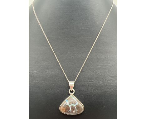 A modern design silver triangular pendant set with a boulder opal, on a 20" fine curb chain with spring clasp. Silver marks t