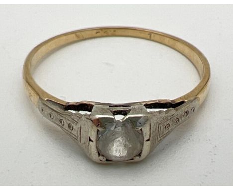 A vintage 9ct gold solitaire ring set with a round cut white topaz stone in a square shaped mount. Engraved detail to shoulde