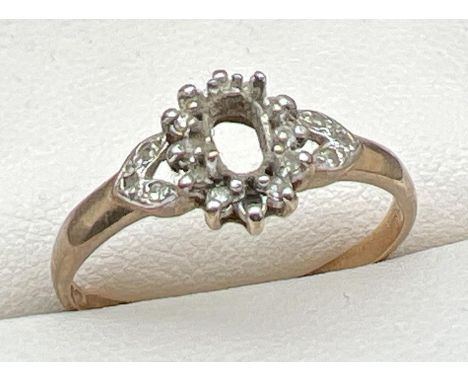 A 9ct gold vintage dress ring set with small round cut diamonds. Central stone missing and one small diamond missing to surro