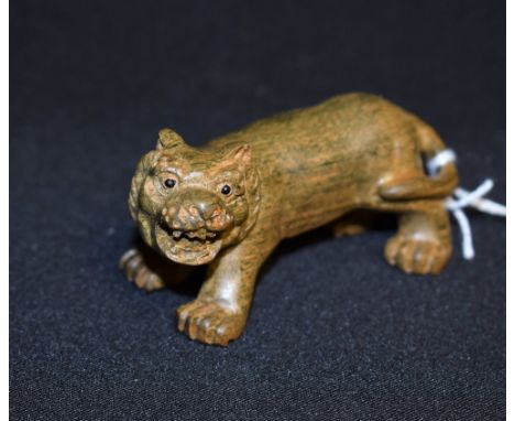 A Japanese netsuke, as a tiger, standing on four, 7.5cm wide, Meiji period