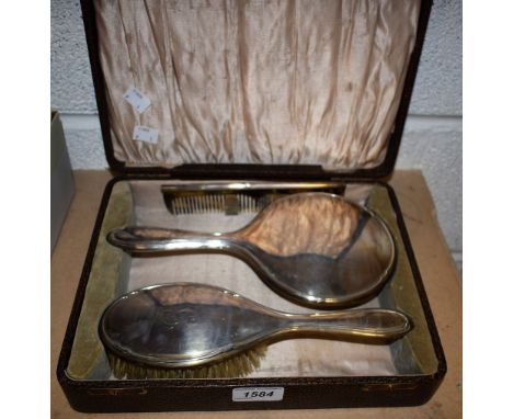 A silver three piece hand mirror and brush set, Birmingham 1929, cased