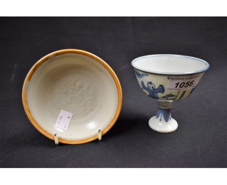A Chinese Qingbai moulded dish, with lotus decoration; a Chinese blue and white stem cup, decorated with boys playing, a wanl