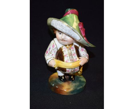 A Royal Crown Derby Short Mansion House Dwarf, he stands wearing a broad brimmed hat, his waistcoat banded in brown and roses