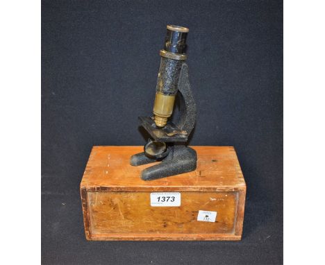 A cased Dolland of London student microscope
