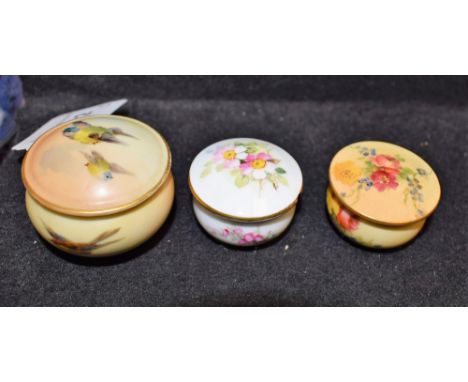 Royal Worcester - a miniature circular lidded pill box, painted with Blue Tits, green printed marks; others, smaller, floral 