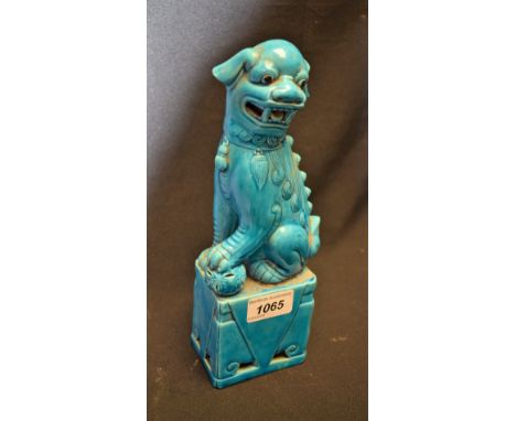 A Chinese Republican turquoise monochrome model, of a temple lion, he sits with one paw on an 'embroidered' reticulated ball,