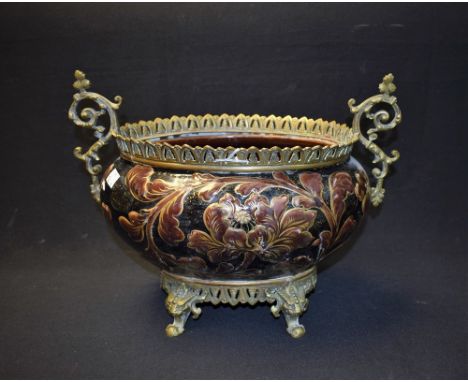 A late 19th century French Luneville ceramic table centre, pierced brass mount with gallery, 38cm wide, 28cm high, impressed 