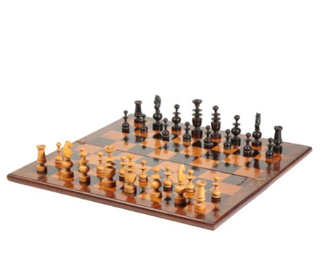 A FRENCH TURNED AND CARVED BOXWOOD AND EBONISED CHESS SET IN REGENCE STYLE, late 19th century; and an associated hinged wood 