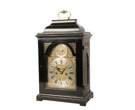 GEORGE III EBONISED BRACKET CLOCK by Hubbard, London, the case with arched door and basket top surmounted by a gilt carrying 