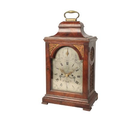 A GEORGE III MAHOGANY BRACKET CLOCK by Samuel Raworth, Plymouth, the case with basket top and brass carrying handle, pierced 