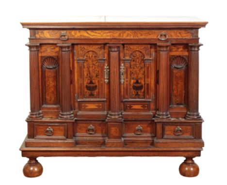 A FINE DUTCH OAK AND ELM SCHRANK, late 17th /early 18th century, the cleated rectangular top above a slide with twin wrought 