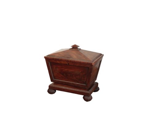 A REGENCY MAHOGANY CELLARET, IN THE MANNER OF GILLOWS, circa 1815, of sarcophagus form, the hinged pyramidal cover with pyram