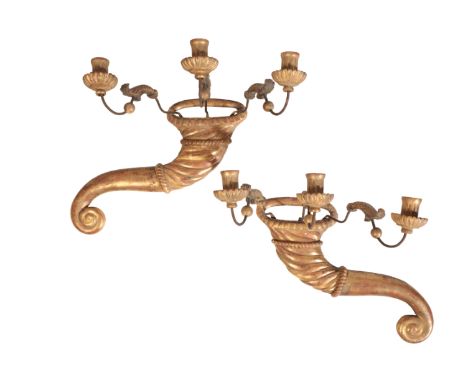 A PAIR OF ITALIAN CARVED AND GILTWOOD THREE LIGHT WALL APPLIQUES, the fluted sockets on serpentine metal arms rising from bac