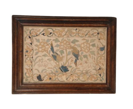 A SILKWORK EMBROIDERY PANEL, 18th century, depicting birds and animals amongst flowers and foliage, within a conforming trail