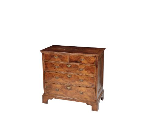 A GEORGE II WALNUT AND FEATHEER BANDED CHEST OF DRAWERS, circa 1740, the rectangular quarter veneered top above two short and