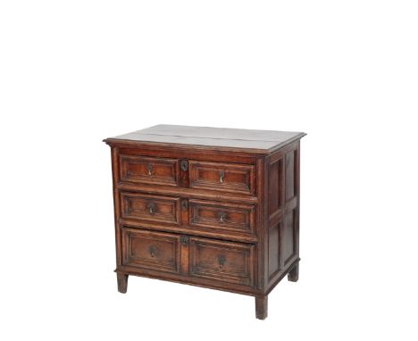 AN OAK CHEST OF DRAWERS, late 17th century, the rectangular top with moulded front and side edges, the three long drawers mod