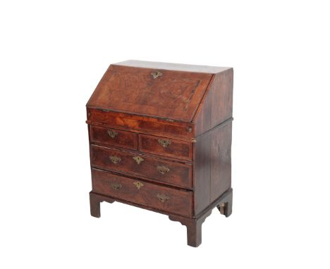 A GEORGE II WALNUT AND CROSSBANDED BUREAU, second quarter 18th century, with fall front to a fully fitted interior with well,
