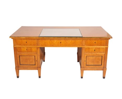 A NORTH EUROPEAN SATINBIRCH DESK IN BIEDERMEIER STYLE, second half 20th century, the top with inset rectangular glass panel, 