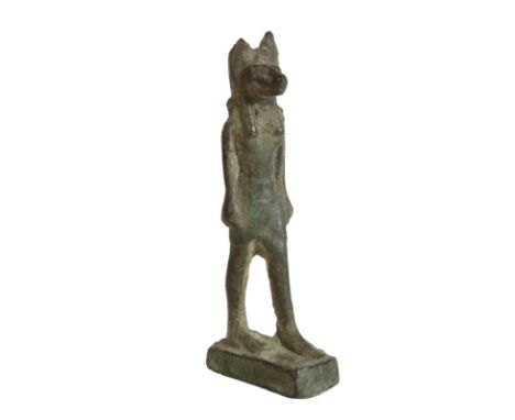 AN EGYPTIAN BRONZE MODEL OF ANUBIS, probably Late Period, 712 - 323 B.C., cast standing, with arms at his sides, his left foo
