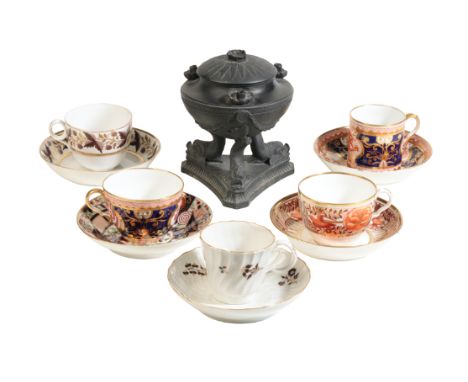 A WEDGWOOD BLACK BASALT BRULE PARFUM of neo-classical design with dolphin supports on a fluted triangular base, the base with