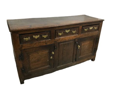 AN OAK DRESSER BASE, early 18th century and later elements, the rectangular top with moulded front and side edges, above thre
