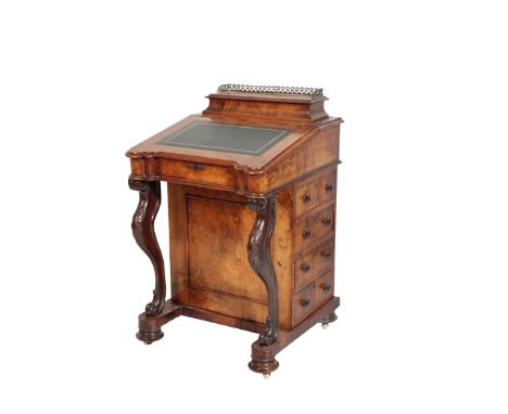 A VICTORIAN WALNUT DAVENPORT, circa 1870, the superstructure with hinged top and three quarter brass gallery, opening to a fi