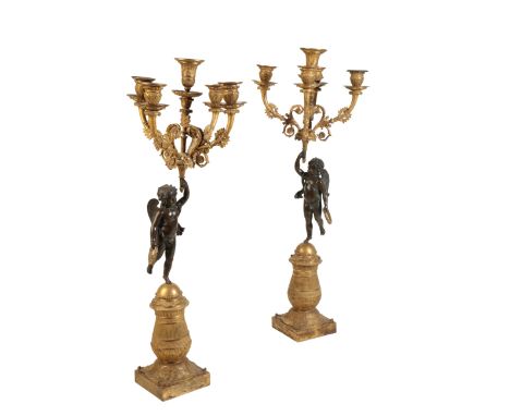 A PAIR OF RESTAURATION GILT AND PATINATED BRONZE FIGURAL FIVE LIGHT CANDELABRA, circa 1825, with foliate cast urn sockets on 