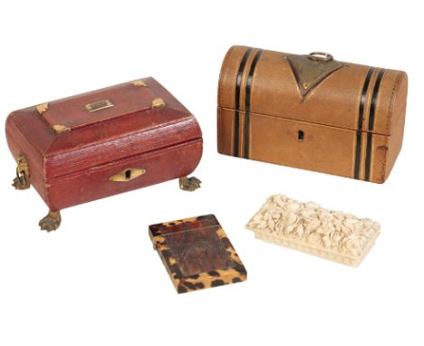 A REGENCY RED LEATHER FACED SEWING CASKET, circa 1815, of sarcophagus form, with lion's mask and ring handle at each end, on 