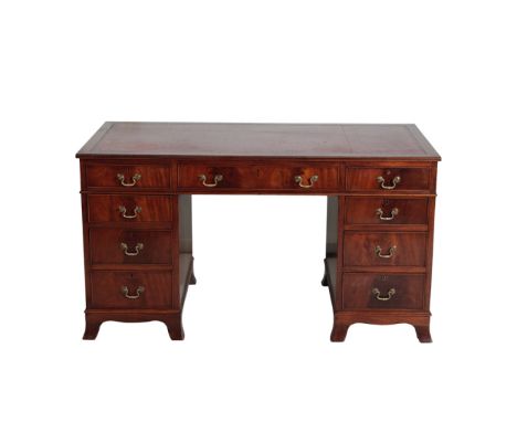 A MAHOGANY PEDESTAL DESK IN GEORGE III STYLE, second half 20th century, the rectangular top with inset gilt tooled red leathe