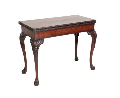 A GEORGE II CARVED MAHOGANY CARD TABLE, circa 1740, the hinged rectangular top with ribbon carved edges, the cabriole legs wi