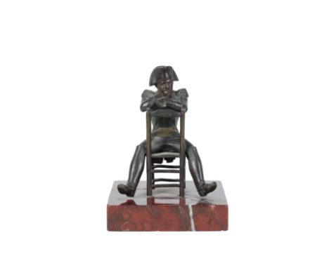A FRENCH BRONZE MODEL OF NAPOLEON BONAPART, late 19th century, portrayed as seated astride a ladderback chair, on a square se