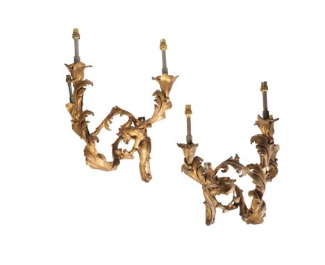 TWO PAIRS OF GILT COMPOSITION THREE LIGHT WALL APPLIQUES, IN LOUIS XV STYLE, late 19th Century, the later electrical fitments