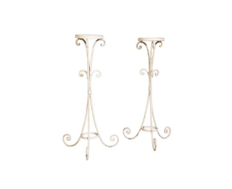 A PAIR OF WHITE PAINTED WOOD AND WROUGHT IRON MOUNTED TRIPOD STANDS, early 20th century, the circular tops on scrolled stems 