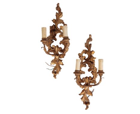 A PAIR OF CONTINENTAL CARVED AND GILTWOOD TWIN LIGHT WALL APPLIQUES, IN 18TH CENTURY STYLE, 20th century, the electrical fitm