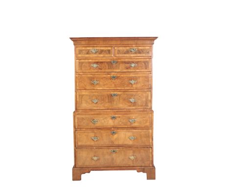 A GEORGE II WALNUT AND FEATHER BANDED CHEST ON CHEST, mid 18th century, the upper section with moulded cornice above two shor