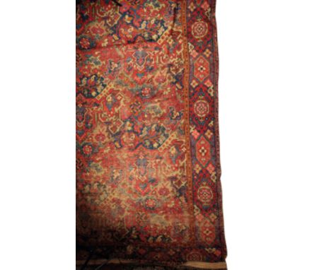 A LARGE TURKISH CARPET FRAGMENT with typical geometric and stylised foliate decoration in tones of indigo, madder and green, 
