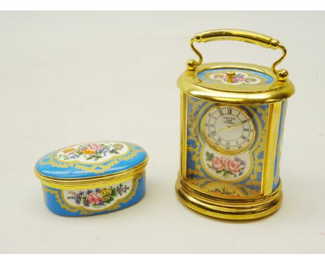 Halcyon Days miniature carriage clock of oval form with cartouche panels decorated with flowers, brass frame and handle, H10.
