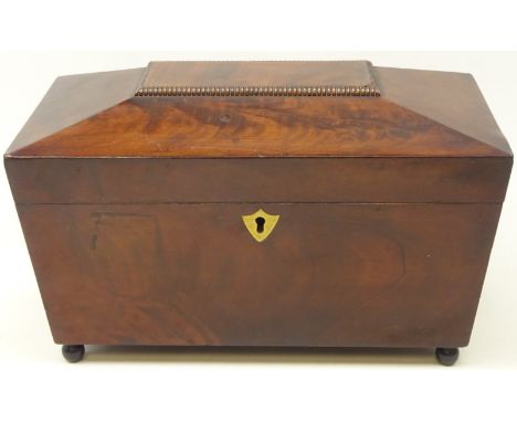 19th century mahogany tea caddy of sarcophagus form, two division lidded interior with etched glass mixing bowl on four ball 