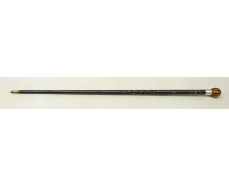 Ebony walking cane with part carved spiral shaft and inlaid decoration with globular alternate light and dark wood pommel and