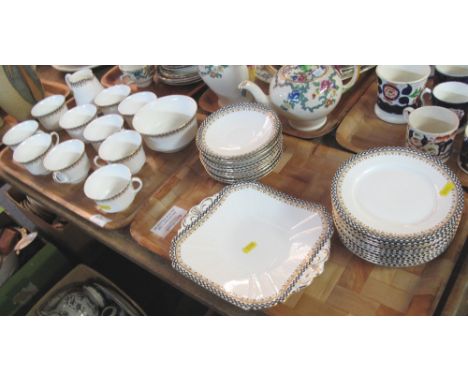 Two trays of Shelley china teaware on a white ground with black and white chequered banding and gilt work, comprising: teacup