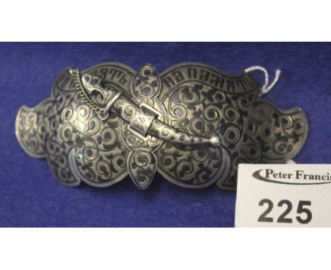 Russian Niello silver foliate design belt buckle with chain linked securing bar in the form of a dagger, dated: 1884.