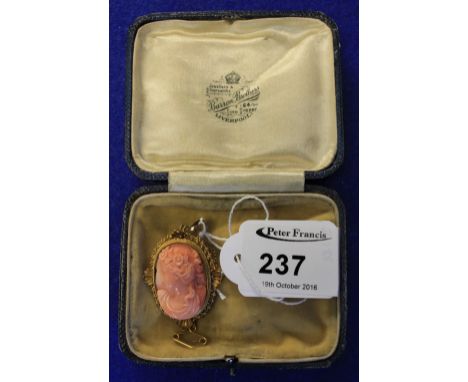 Victorian pink stone portrait brooch pendant in 12ct gold scroll and shell work setting.  Boxed. CONDITION REPORT: Cracks to 