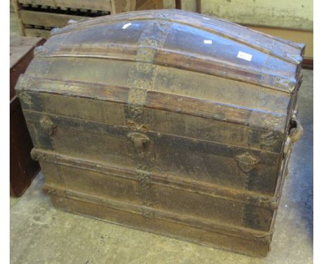 Vintage dome topped two handled travelling trunk with metal and wooden mounts.